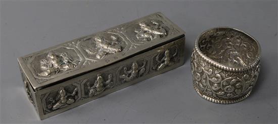 An Indian embossed white metal rectangular snuff? box and a white metal napkin ring.